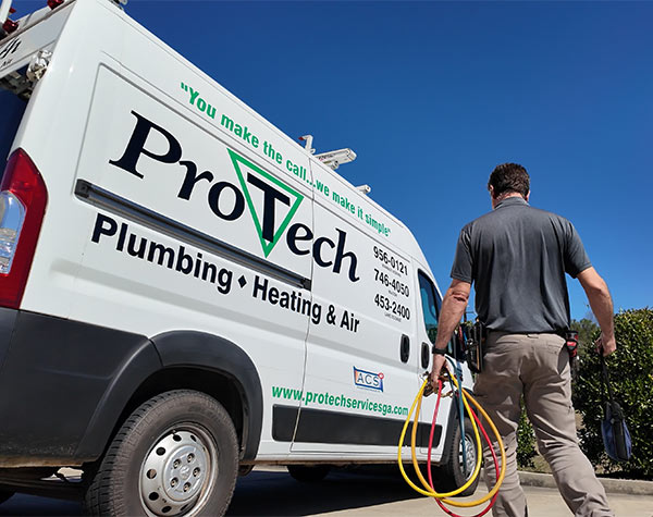 service technician walking towards Total Comfort van