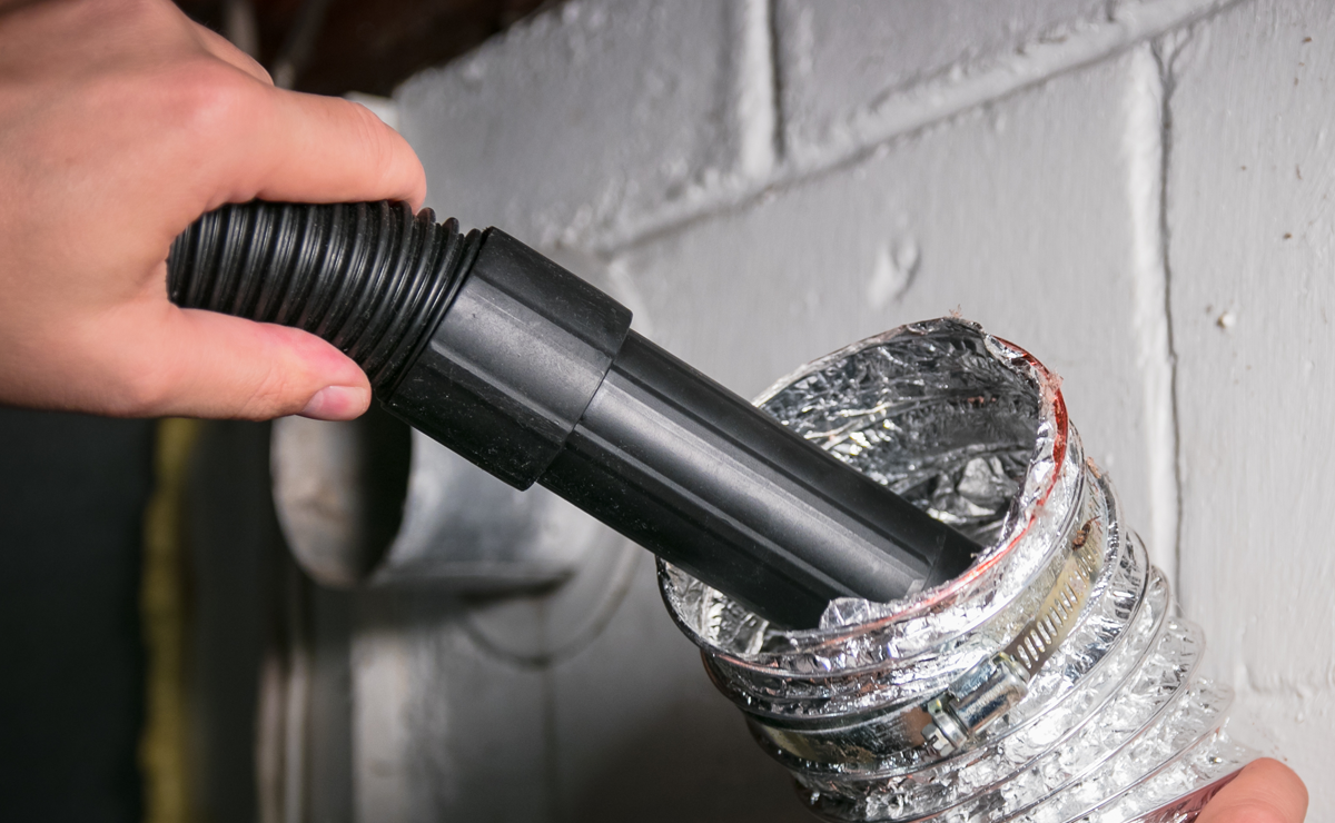 Vacuum cleaning a flexible aluminum dryer vent hose, to remove lint and prevent fire hazard.