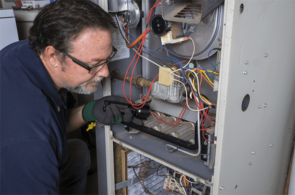 HVAC technician checking furnace